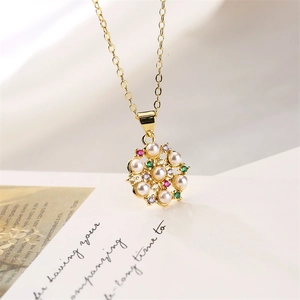 Macro detail of golden flower pendant with white pearls and multicolor gemstones