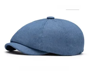 Close-up of navy blue denim newsboy cap showing fabric texture and neat stitching