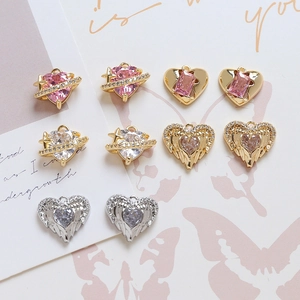 Macro shot of assorted heart pendants with pink and clear zircon in gold and silver finish