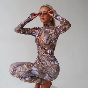 Close-up of the fluid metallic print and teardrop cutout detail on the long sleeve bodysuit