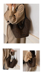 Detail of leopard print tote bag with black leather straps and premium fabric texture