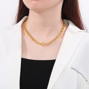 Detail of two-tone gold necklace with Cuban and thin chain combination on a model