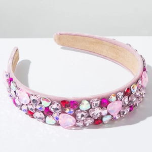 Close-up of pink velvet headband with colorful heart-shaped rhinestones and soft lining
