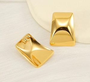 Detailed macro view of 18k gold-plated stainless steel rectangular stud earrings