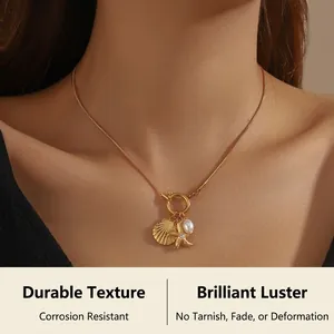 Detail of gold starfish and shell pendant necklace with pearl on a snake chain