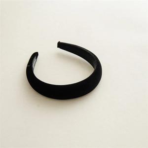 Detailed view of the thick matte velvet padded headband in classic black fashion
