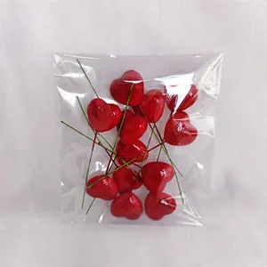 Detail of glossy red foam hearts with long green stems for DIY floral crafts and cakes