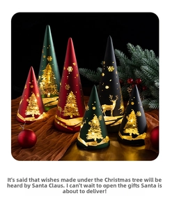 Detail of cone-shaped Christmas glass lanterns with reindeer and snowflake cutouts