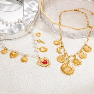 Detail of vintage heart pendants and celestial charms on gold and pearl necklaces