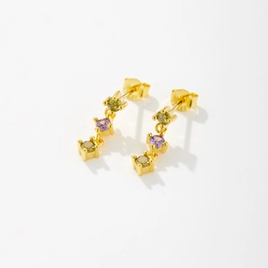 Detail showing S925 silver stamp on gold drop earrings with purple and green zircons