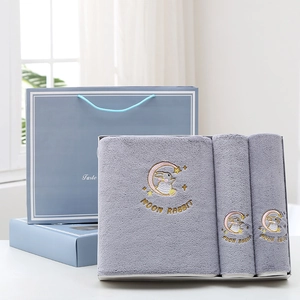Detail of gray bath towel set featuring moon rabbit embroidery and premium gift packaging