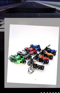 Detail of colorful mini pull-back motorcycle keychains in assorted racing styles