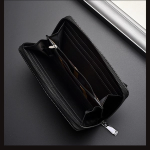 Interior view of black carbon fiber wallet showing multi-card slots and zipper compartment