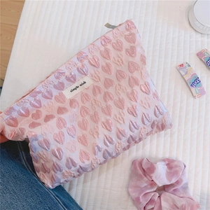 Detail of pink jacquard fabric with textured 3D hearts and Simple Wish brand label