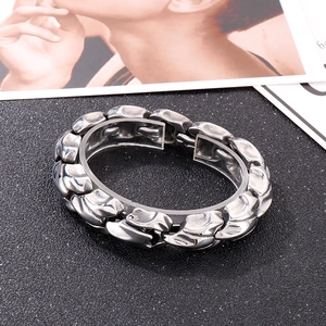 Detailed view of heavy metal dragon bone link chain bracelet in polished stainless steel