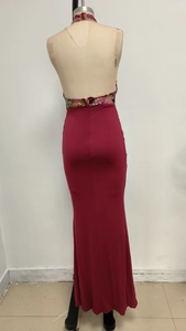 Macro detail of the sheer mesh back with sequined floral embroidery on the burgundy gown