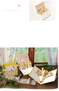 Detail showing colorful 3D pop-up floral greeting cards in a cozy lifestyle setting
