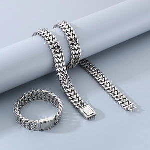 Polished stainless steel heart link bracelet and necklace set on display stands