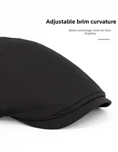 Detail of a foldable wide brim on a breathable black flat cap for face contouring
