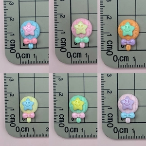 Detailed size view of colorful star candy resin charms with a ruler measurement scale