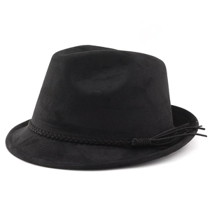 Detail of black suede cowboy hat featuring a braided band and side tassel ornament