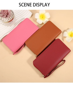 Detail of three macaron long wallets with litchi texture and secure wrist straps