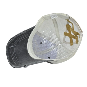 Internal detail of washed baseball cap with elastic criss-cross high ponytail design