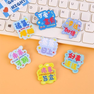 Cute acrylic inspirational slogan brooches set on white keyboard background