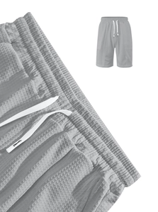 Macro shot of grey waffle fabric texture and white drawstring on casual sports shorts
