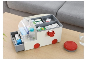 Detail of ambulance style medical box with multi-layer storage on wooden table