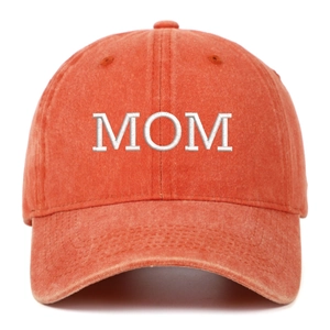 Macro detail of MOM embroidery on a vintage orange washed cotton baseball cap