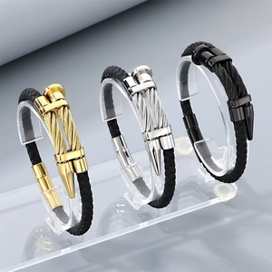 Detailed view of punk nail head bracelets in gold, silver, and black stainless steel