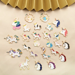 Enamel unicorn pendants in multiple colors on gold fabric for DIY jewelry making