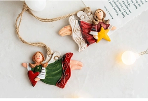 Detail of vintage resin angel ornaments with star and heart on rustic background