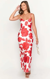 Detail shot of white floral maxi dress with red flowers and silky satin texture
