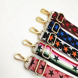 Detail of adjustable woven straps with star patterns and gold metal swivel hooks