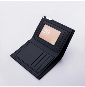 Detail view of leather wallet featuring card slots, ID window and metal corner trim