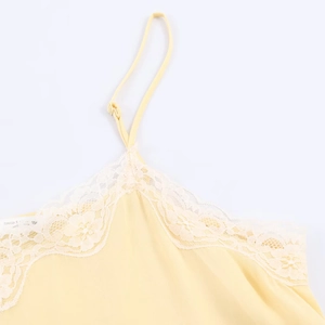 Detail of the delicate lace neckline and fabric texture on a pale yellow camisole top