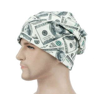 Detail of money print beanie featuring $100 bill design on soft creamy knit fabric