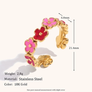 Detail showing pink enamel flowers on an 18K gold plated stainless steel ring band