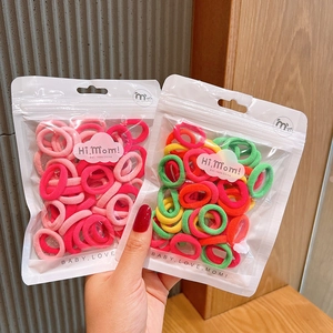 Detail of high-elasticity colorful hair ties in a transparent zipper bag