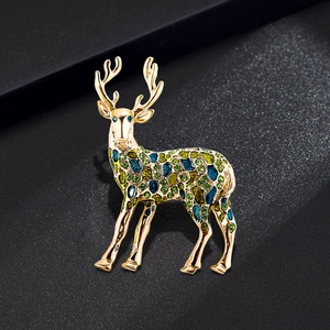Exquisite golden reindeer brooch with colorful green and blue gemstones for Christmas
