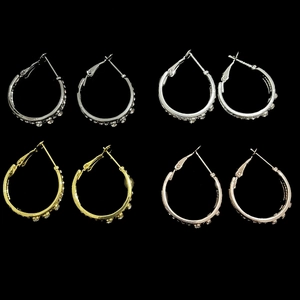 Detail showing four colors of sparkling hoop earrings with micro-set rhinestones