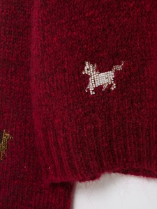 Close-up of dark red mohair sweater featuring delicate white beaded horse embroidery