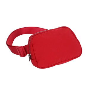 Detail of red athletic waist bag with waterproof nylon fabric and adjustable plastic buckle