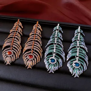 Vintage peacock feather tassel earrings with crystals in gold and silver settings