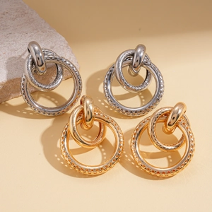 Golden and silver geometric hollow round earrings with textured multi-ring design