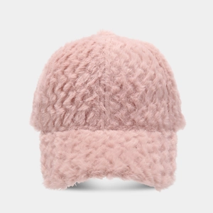 Detail of pink faux fur baseball cap showing thick plush texture and curved brim for winter