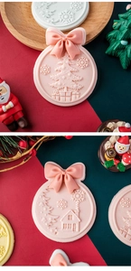 Detailed view of pink fondant cookie stamps with Christmas tree and bow tie relief patterns