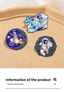 Detail of three creative astronaut enamel pins featuring space exploration and whale theme